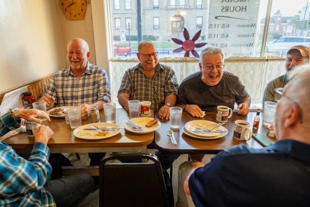 From back left: Tim Searby, Don Ruff, Greg Shanie, and Chuck Gunning enjoy their weekly Thursday morning breakfast together at Mama's Arcade Cafe in Lincoln, Illinois, on Oct. 3, 2024. (Tess Crowley/Chicago Tribune)