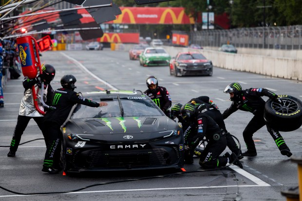 Pit crew members work on the car of Ty Gibbs #54 during the Grant Park 165 of the NASCAR Street Race on July 7, 2024, at Grant Park in Chicago. (Vincent Alban/Chicago Tribune)