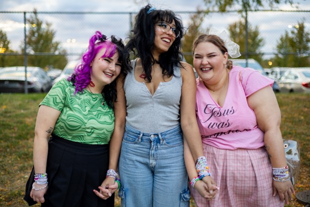 From left: Madysun Wynkoop, friend Cassie Cerpa, and aunt Angela Wynkoop from Clinton, Iowa, wear friendship bracelets while waiting in line to enter the United Center for Sabrina Carpenter's Short N' Sweet Tour in Chicago on Oct. 13, 2024. (Tess Crowley/Chicago Tribune)