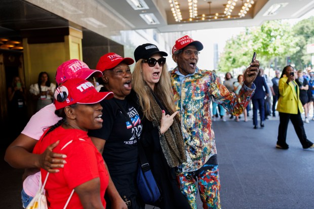 George Blakemore, right, chants with other supporters as former President Donald Trump attends the National Association of Black Journalists convention near South Michigan Avenue on July 31, 2024 in Chicago. (Armando L. Sanchez/Chicago Tribune)