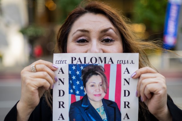 Paloma Andrade shows her 2007 campaign poster outside the Dunne Cook County Office Building in Chicago on Oct. 9, 2024. (Tess Crowley/Chicago Tribune)