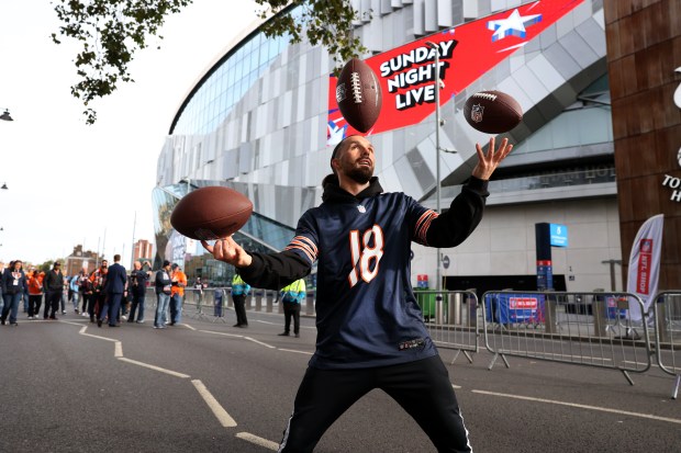 Andrew Wilding (cq) juggles footballs while entertaining outside of Tottenham Hotspur Stadium in London before a game between the Chicago Bears and the Jacksonville Jaguars on Oct. 13, 2024.  (Chris Sweda/Chicago Tribune)