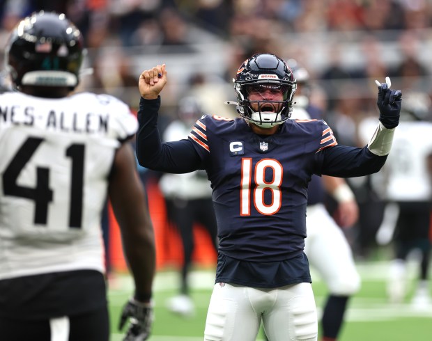 Bears quarterback Caleb Williams celebrates after throwing a pass to wide receiver DJ Moore in the fourth quarter against the Jaguars on Oct. 13, 2024, at Tottenham Hotspur Stadium in London. (Chris Sweda/Chicago Tribune)