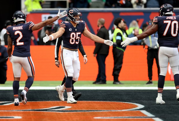 Bears tight end Cole Kmet (85) is congratulated by teammates after scoring a touchdown in the second quarter against the Jaguars at Tottenham Hotspur Stadium in London on Oct. 13, 2024. (Chris Sweda/Chicago Tribune)