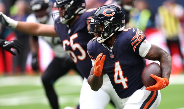 Chicago Bears running back D'Andre Swift (4) looks for an opening in the defense in the second quarter of a game against the Jacksonville Jaguars at Tottenham Hotspur Stadium in London on Oct. 13, 2024. (Chris Sweda/Chicago Tribune)