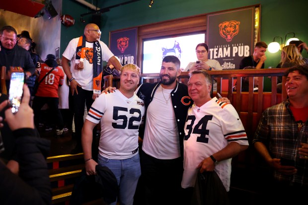 Former Bears tight end Zach Miller poses for a photograph with Leon Lucas (52) and his father, Torsten Lucas, of Hamburg, Germany, at the Greenwood Sports Pub on Oct. 11, 2024, in London. (Chris Sweda/Chicago Tribune)