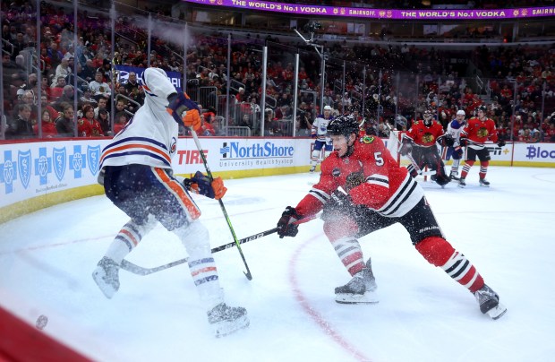 Edmonton Oilers center Leon Draisaitl (29) and Chicago Blackhawks defenseman Connor Murphy (5) battle for the puck in the second period of a game at the United Center in Chicago on Jan. 9, 2024. (Chris Sweda/Chicago Tribune)