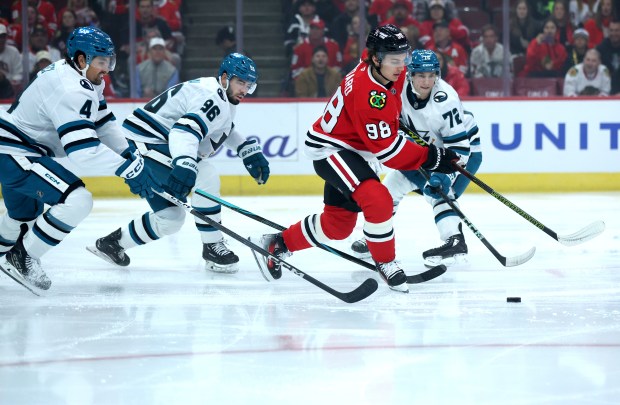 Blackhawks center Connor Bedard) looks to make a move as the Sharks defense applies pressure in the first period at the United Center on Oct. 17, 2024. (Chris Sweda/Chicago Tribune)