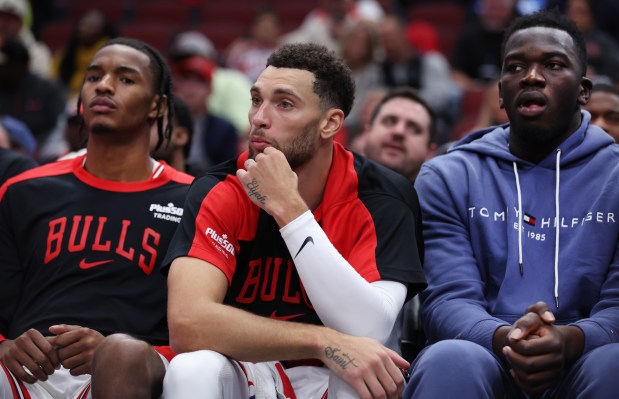 Guard Zach LaVine, center, sits on the bench late in the second half of the Bulls home opener against the Thunder on Oct. 26, 2024, at the United Center. The Bulls lost 114-95. (Chris Sweda/Chicago Tribune)