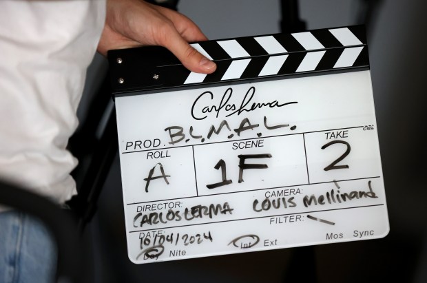 A clapperboard is held on set as Columbia College film student Carlos Lerma shoots his 4-minute short called "Boys Like Me Ain't Lucky" in Chicago's South Loop, Oct. 4, 2024. (Chris Sweda/Chicago Tribune)