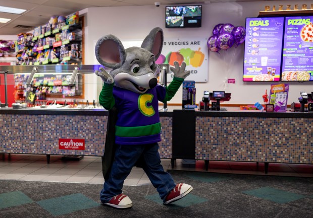 A costumed Chuck E. Cheese walks through a recently remodeled location in Gage Park on Oct. 17, 2024. (Brian Cassella/Chicago Tribune)