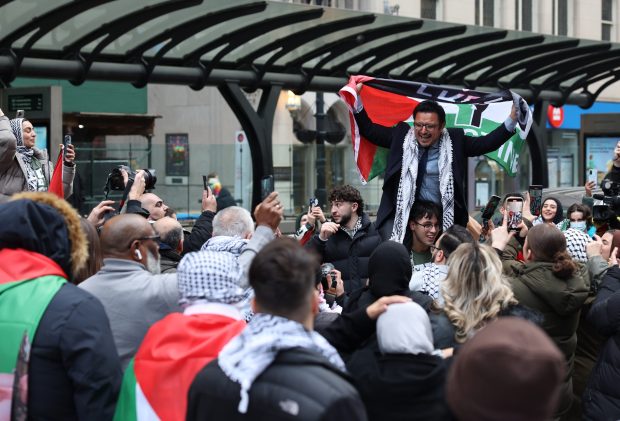 Ald. Byron Sigcho-Lopez, 25th, is hoisted on a demonstrator's shoulders as they celebrate after the City Council passed a cease-fire resolution in the Israel-Hamas War at Daley Plaza on Jan. 31, 2024, in Chicago. (John J. Kim/Chicago Tribune)