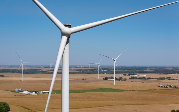 Working turbines spin in the wind over farmland in Henry County, Oct. 2, 2024. (Brian Cassella/Chicago Tribune)