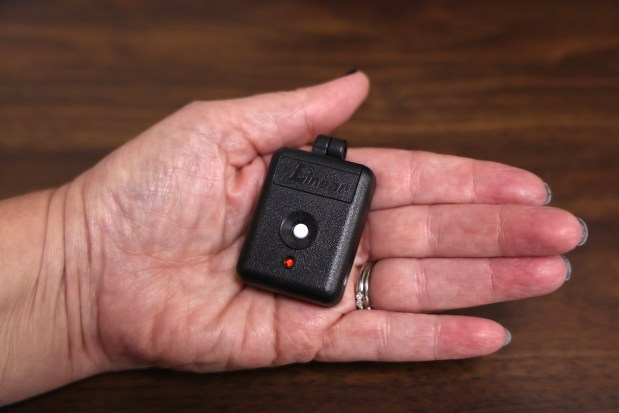 The Boone County Clerk holds one of five panic buttons spread throughout the Boone County Clerk's office on Oct. 25, 2022, in Belvidere. (Stacey Wescott/Chicago Tribune)