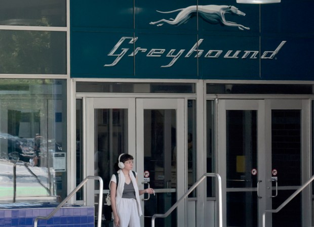 A person stands outside the Greyhound bus station at 630 W. Harrison St. in Chicago on Aug. 27, 2024. (Antonio Perez/Chicago Tribune)