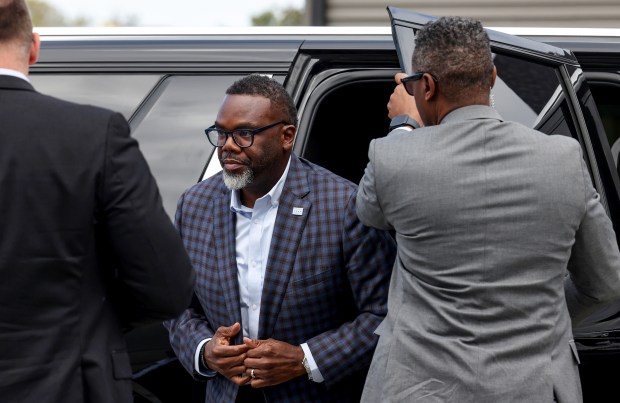 Mayor Brandon Johnson emerges from his SUV for an event on South Wentworth Avenue, Sept. 30, 2024, where he responded to questions from reporters about Chicago Public Schools CEO Pedro Martinez. (Antonio Perez/Chicago Tribune)