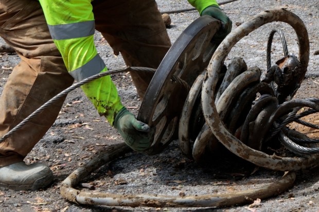 Discarded lead pipe is removed from a home in the 10100 block of South Green Street in Chicago on May 2, 2024. (Antonio Perez/Chicago Tribune)