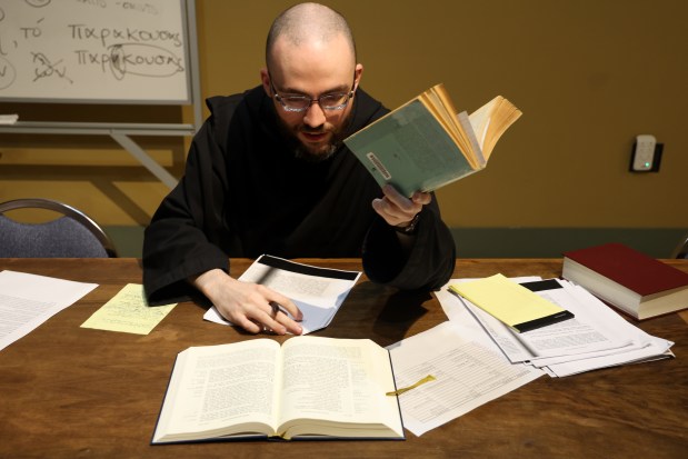 Benedictine monk Brother Anthony Daum studies Greek translations at the Monastery of the Holy Cross in Chicago, Sept. 20, 2024. (Antonio Perez/Chicago Tribune)