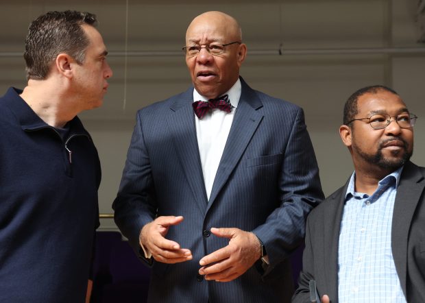 CPS board nominee Rev. Mitchell Johnson, center, speaks with attendees as Mayor Brandon Johnson debuted his picks for the Chicago Board of Education, on Oct. 7, 2024. (Antonio Perez/Chicago Tribune)