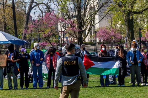 Students gather at a Pro-Palestinian encampment after police attempted to remove the tents earlier in the day at Northwestern University on Thursday, April 25, 2024, in Evanston. (Armando L. Sanchez/Chicago Tribune)