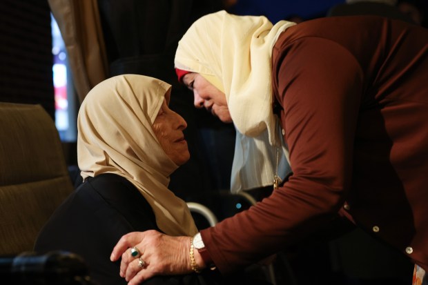 Nadia Hussien, left, is greeted by her sister-in-law, Zuhdieh Hussien, while gathering with relatives at her brother Adnan's home, Oct. 11, 2024, in Homer Glen. Hussien, 80, and her brother are traveling back to her home in Beitunia in the West Bank of Palestine, in part, to tend to the olive trees on her property despite the potential dangers and travel complications caused by the Israel-Hamas war. (John J. Kim/Chicago Tribune)