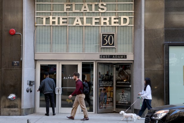 People walk past a soon-to-open Sabrina Carpenter pop up shop at 30 E. Adams Street on Oct. 10, 2024. (Antonio Perez/Chicago Tribune)