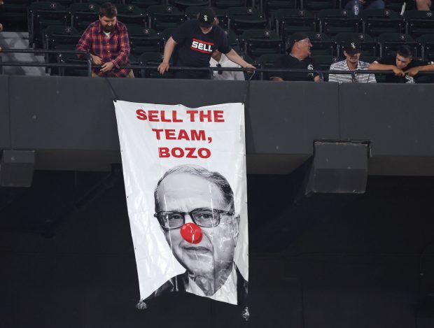 Two people hang a sign depicting White Sox chairman Jerry Reinsdorf as Bozo the clown from the 300 level of Guaranteed Rate Field in Chicago in the ninth inning of a game between the Chicago White Sox and the Baltimore Orioles on May 23, 2024. (Chris Sweda/Chicago Tribune)