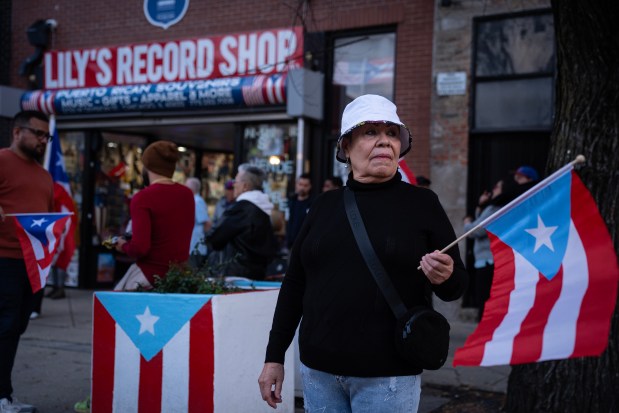 Humboldt Park resident Teresa Gonzales attends a neighborhood rally on Division Street in response to derogatory comments made about Puerto Rico at a Republican nominee former President Donald Trump rally Sunday, Oct. 28, 2024. (E. Jason Wambsgans/Chicago Tribune)