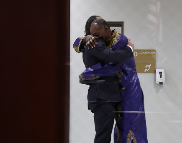 Jackie Wilson hugs his attorney, Elliot Slosar, right, outside of the Rolling Meadows courtroom where Slosar is giving testimony in the trial of former Cook County assistant state's attorneys, Nicholas Trutenko and Andrew Horvat on Oct. 24, 2024. (Stacey Wescott/Chicago Tribune)