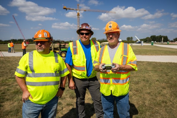 International Union of Operating Engineers Local 150 operators Jeff Sidor, left, Derek Good, center, and Glen Schmidt, right, fly drones during drone training at William E. Dugan Training Center in Wilmington on Sept. 20, 2024. (Tess Crowley/Chicago Tribune)