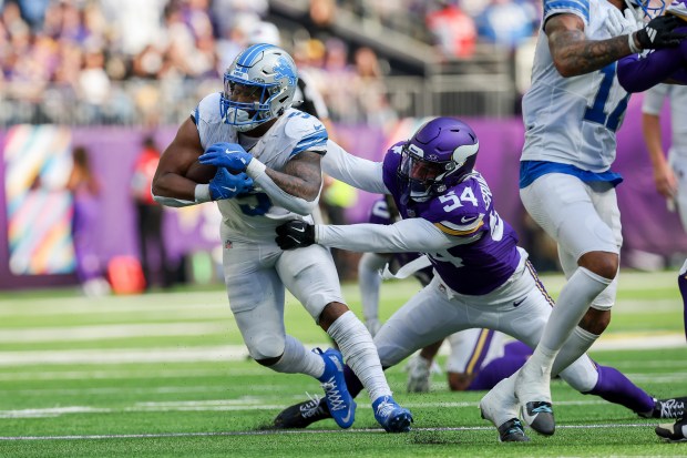 Lions running back David Montgomery controls the ball against Vikings linebacker Kamu Grugier-Hill) during the first half on Oct. 20, 2024, in Minneapolis. Detroit won 31-29. (AP Photo/Stacy Bengs)