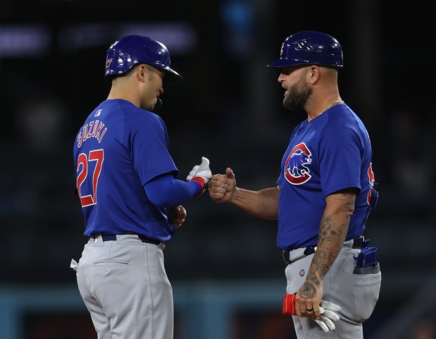 Seiya Suzuki #27 of the Chicago Cubs celebrates his single with Mike Napoli #55, resulting in two runs after a Tommy Edman #25 of the Los Angeles Dodgers error, to tie the game 3-3 during the eighth inning at Dodger Stadium on Sept. 10, 2024 in Los Angeles, California. (Photo by Harry How/Getty Images)