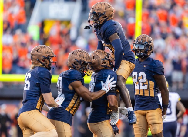 Torrie Cox Jr. #5 of the Illinois Fighting Illini celebrates with Matthew Bailey #7 of the Illinois Fighting Illini after an interception during the second half against the Michigan Wolverines at Memorial Stadium on Oct. 19, 2024 in Champaign, Illinois. (Photo by Michael Hickey/Getty Images)