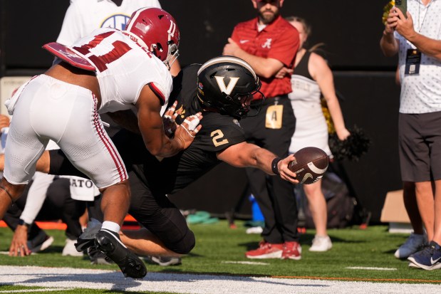 Vanderbilt quarterback Diego Pavia dives for extra yards against Alabama linebacker Jihaad Campbell during the first half on Oct. 5, 2024, in Nashville, Tenn. (George Walker IV/AP)