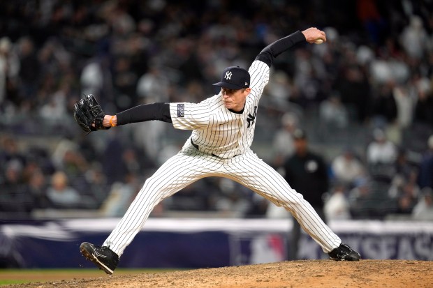 New York Yankees relief pitcher Tim Hill throws against the Cleveland Guardians during the eighth inning in Game 1 of the baseball AL Championship Series Monday, Oct. 14, 2024, in New York. (AP Photo/Godofredo Vásquez)