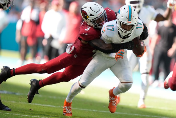 Arizona Cardinals safety Budda Baker (3) tackles Miami Dolphins wide receiver Jaylen Waddle (17) during the second half of an NFL football game, Sunday, Oct. 27, 2024, in Miami Gardens, Fla. (AP Photo/Lynne Sladky)