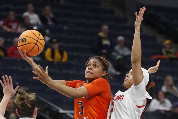 Illinois guard Makira Cook (3) shoots past Maryland guard Brinae Alexander, right, during the second half of an NCAA college basketball game at the Big Ten women's tournament Friday, March 3, 2023, in Minneapolis. Maryland won 73-58. (AP Photo/Bruce Kluckhohn)