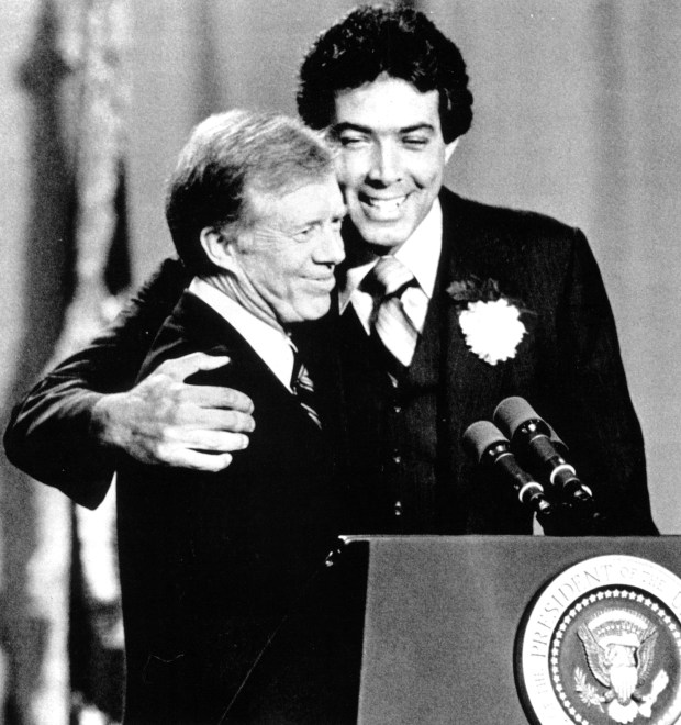 President Jimmy Carter, left, is hugged by U.S. Rep. Marty Russo after an introduction Oct. 16, 1979, at Thornridge High School in Dolton. (UPI photo)