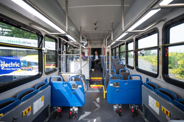 Visitors sit inside of a Gary Public Transportation Corporation all-electric bus on August 9, 2023. (Kyle Telechan for the Post-Tribune)