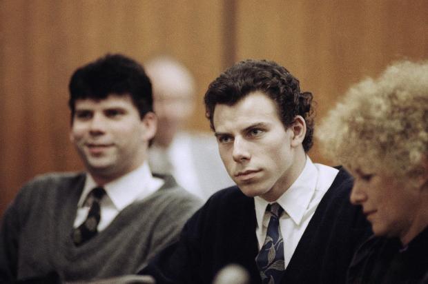 Lyle, left, and Erik Menendez sit with defense attorney Leslie Abramson, right, in Beverly Hills Municipal Court during a hearing, Nov. 26, 1990. (AP Photo/Nick Ut, File)