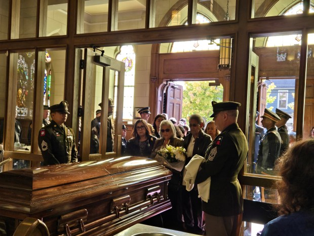 Family members walk behind the casket containing the remains of Army Cpl. Eriverto Ortiz, a recently identified soldier killed 74 years ago in the Korean War. Funeral services were held Monday at St. Mary's Catholic Church in Elgin. (Gloria Casas/The Courier-News)