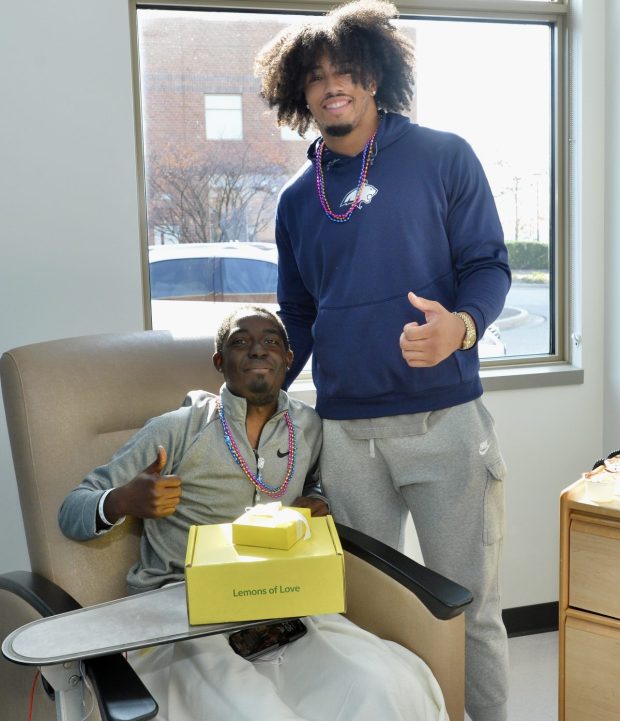 Kyler Isabell-Nappier poses for a photo with Chicago Bears football player Daniel Hardy during a visit the defensive end made Tuesday to Advocate Sherman Hospital Cancer Center. Isabell-Nappier also was presented with a gift box from Bears Care and its charitable partner, Lemons of Love. (Advocate Health Care)