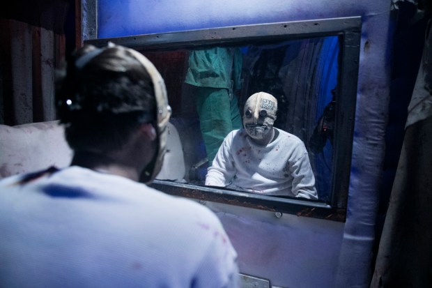 An actor inside Dungeon of Doom haunted house in Zion in 2019, in a somewhat prescient costume.