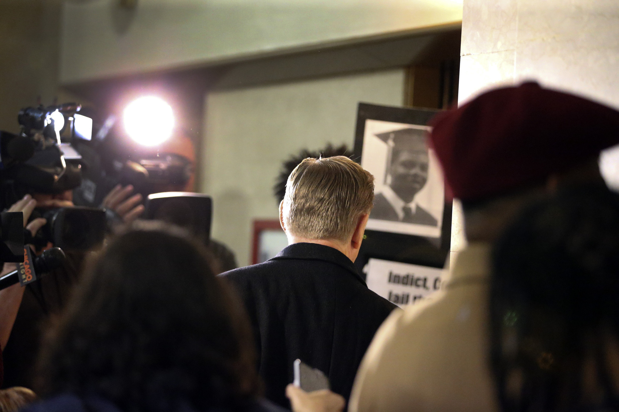 The Rev. Michael Pfleger, center, pastor at St. Sabina Church,...