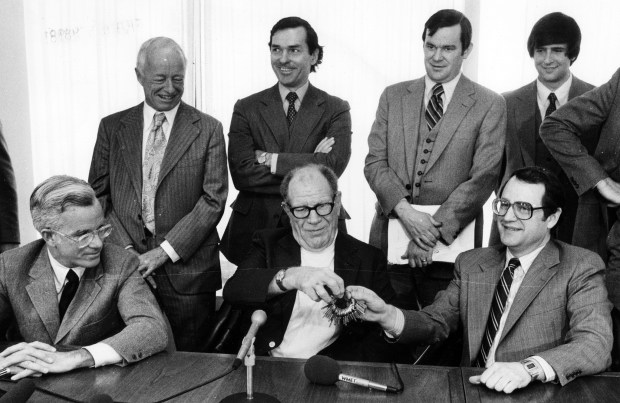 Former White Sox owner Bill Veeck hands over the keys to Comiskey Park to new (and present) White Sox owner Jerry Reinsdorf on Feb. 3, 1981. Seated from left are Andy McKenna, acting chairman, Bill Veeck, and Jerry Reinsdorf. (Yates, Chicago Tribune) ....OUTSIDE TRIBUNE CO.- NO MAGS, NO SALES, NO INTERNET, NO TV, CHICAGO OUT, NO DIGITAL MANIPULATION... BASEBALL