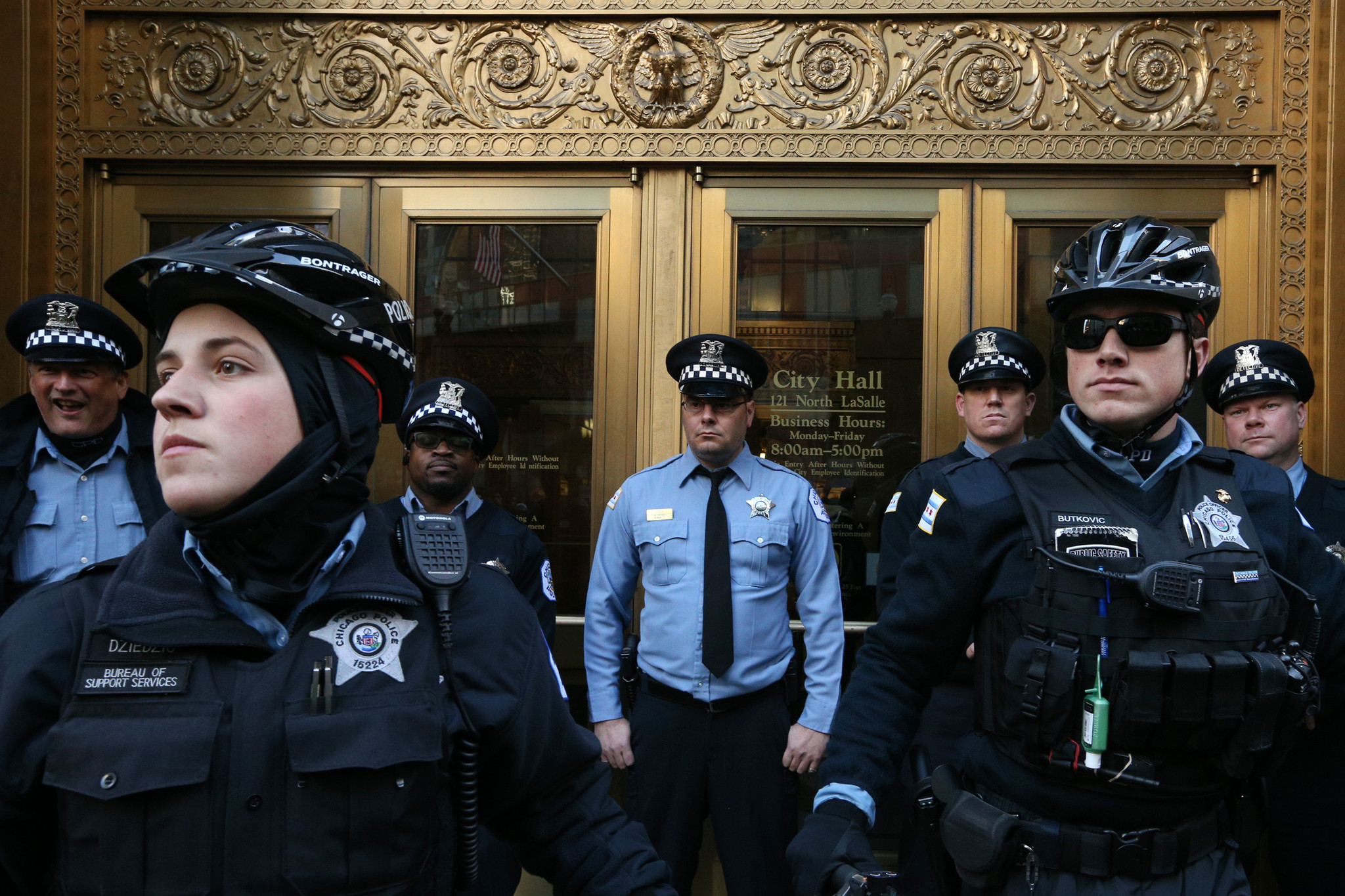 Chicago police officers block entry to City Hall during a...