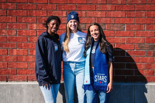 Jameese Joseph, Ava Cook and Mallory Swanson pose with the new Chicago Stars FC crest. (Chicago Red Stars)