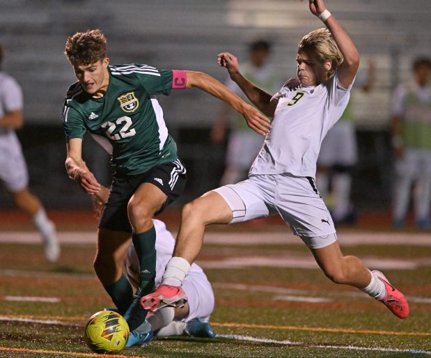 Stevenson's Jack Bacher (22) pushes the ball past Warren's Charlie Crowson (9) during a Class 3A Rolling Meadows Regional semifinal on Tuesday, Oct. 22, 2024. Stevenson won 1-0. (Brian O'Mahoney for the News-Sun)