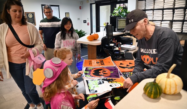 Far right, encouraging children to choose their design of a trick or treat bag is Melissa Spencer of Lincolnshire at Halloween Hoopla on Oct. 19, 2024 in Deerfield at Sachs Recreation Center. (Karie Angell Luc/Lake County News-Sun).