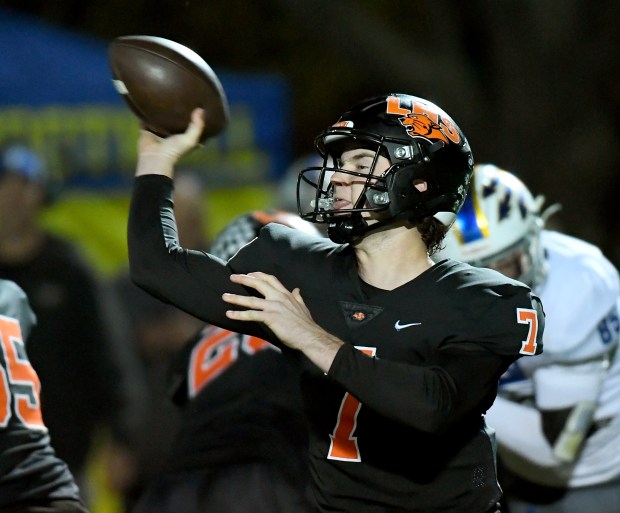 Libertyville's Quinn Schambow (7) throws for a touchdown. Libertyville's football team defeated Warren 35-28 at Libertyville High School, Friday Oct. 25, 2024. (Rob Dicker / for the News-Sun)